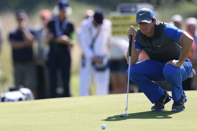 Rory McIlroy of Northern Ireland lines up a putt on the 5th green during the first day of the British Open Golf championship at the Royal Liverpool golf club, Hoylake, England, Thursday July 17, 2014. (AP Photo/Scott Heppell)