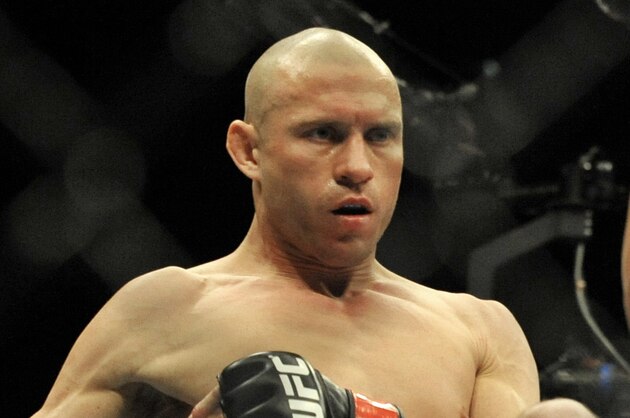 Donald Cerrone left, kicks Adriano Martins right, during the lightweight bout of an UFC mixed martial arts match in Chicago, Saturday, Jan., 25, 2014. (AP Photo/Paul Beaty)