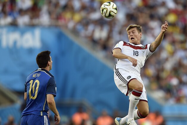 Germany's Toni Kroos (18) rises above Argentina's Lionel Messi (10) to head the ball during the World Cup final soccer match between Germany and Argentina at the Maracana Stadium in Rio de Janeiro, Brazil, Sunday, July 13, 2014. (AP Photo/Martin Meissner)