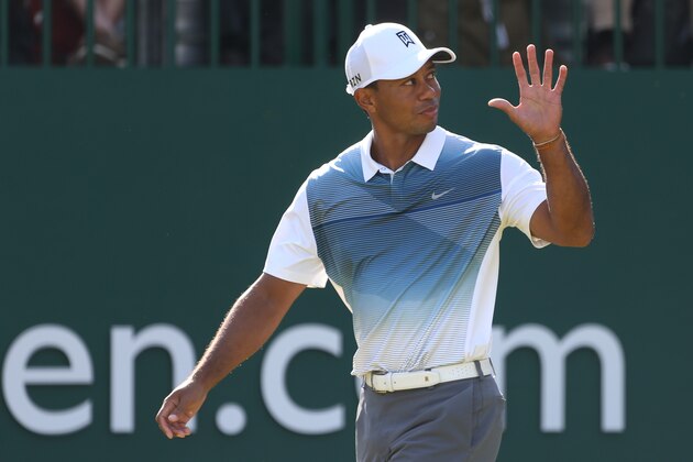 Tiger Woods of the US waves to the crowd as he walks onto the 1st tee during the first day of the British Open Golf championship at the Royal Liverpool golf club, Hoylake, England, Thursday July 17, 2014. (AP Photo/Peter Morrison)