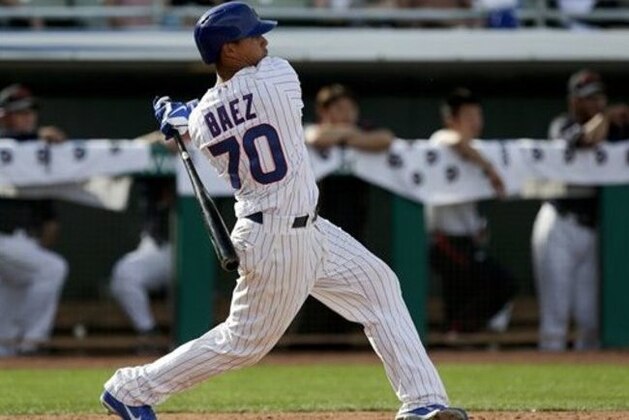 Chicago Cubs' Javier Baez watches his walk off two-run home run against Japan during the bottom the ninth inning of an exhibition spring training baseball game in Mesa, Ariz. Friday, March 15, 2013. (AP Photo/Chris Carlson)