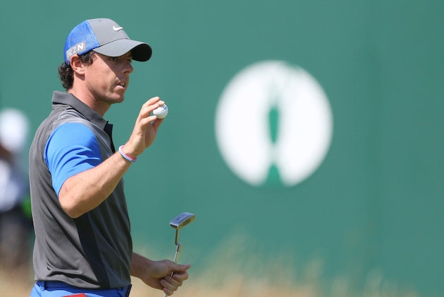Rory McIlroy of Northern Ireland holds up his ball on the 18th green after his round on the first day of the British Open Golf championship at the Royal Liverpool golf club, Hoylake, England, Thursday July 17, 2014. (AP Photo/Peter Morrison)