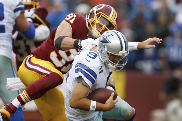 Dallas Cowboys quarterback Tony Romo is sacked by Washington Redskins outside linebacker Ryan Kerrigan during the second half of an NFL football game in Landover, Md., Sunday, Dec. 22, 2013. (AP Photo/Evan Vucci)