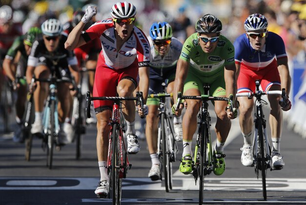 Norway's Alexander Kristoff, center left, crosses the finish line ahead of Peter Sagan of Slovakia, second right, and France's Arnaud Demare, right, to win the twelfth stage of the Tour de France cycling race over 185.5 kilometers (115.3 miles) with start in Bourg-en-Bresse and finish in Saint-Etienne, France, Thursday, July 17, 2014. (AP Photo/Peter Dejong)