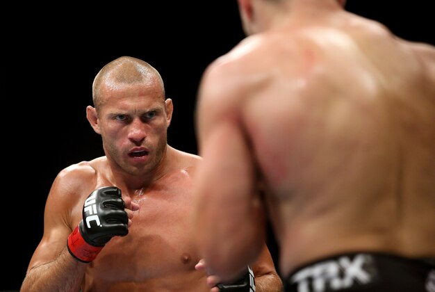 Jul 16, 2014; Atlantic City, NJ, USA; Donald Cerrone (red gloves) stares down Jim Miller (blue gloves) during a 5-round lightweight bout at Revel Casino. Mandatory Credit: Bill Streicher-USA TODAY Sports