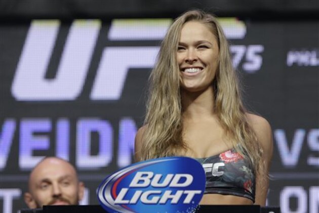 Ronda Rousey stands on the scale during a weigh-in for the UFC 175 mixed martial arts event at the Mandalay Bay, Friday, July 4, 2014, in Las Vegas. Rousey is scheduled fight Alexis Davis in a women's bantamweight title fight on Saturday in Las Vegas. (AP Photo/John Locher)