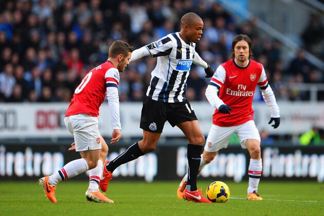NEWCASTLE UPON TYNE, ENGLAND - DECEMBER 29: Loic Remy of  Newcastle United is closed down by Jack Wilshere (L) and Tomas Rosicky of Arsenal during the Barclays Premier League match between Newcastle United and Arsenal at St James' Park on December 29, 2013 in Newcastle upon Tyne, England.  (Photo by Michael Regan/Getty Images)