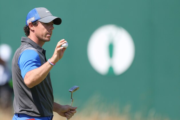 Rory McIlroy of Northern Ireland holds up his ball on the 18th green after his round on the first day of the British Open Golf championship at the Royal Liverpool golf club, Hoylake, England, Thursday July 17, 2014. (AP Photo/Peter Morrison)