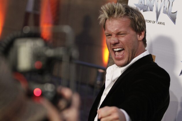 Professional wrestler Chris Jericho gestures to a photographer as he arrives at the premiere of