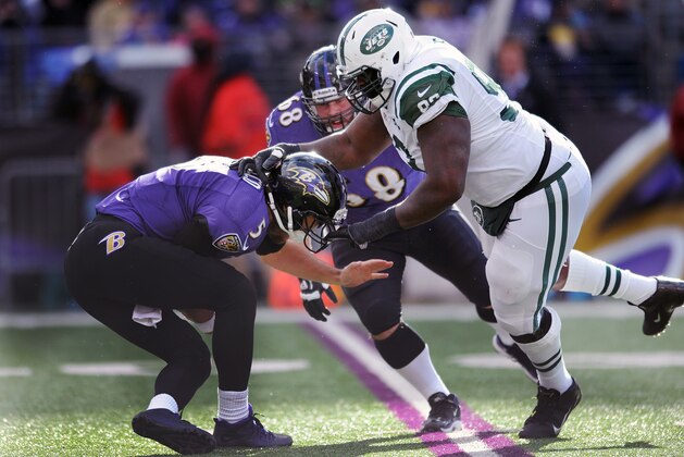 Baltimore Ravens quarterback Joe Flacco is sacked by New York Jets defensive end Kenrick Ellis during the first half of an NFL football game in Baltimore, Md., Sunday, Nov. 24, 2013. (AP Photo/Gail Burton)