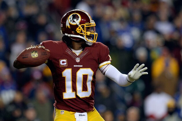 LANDOVER, MD - DECEMBER 01:  Robert Griffin III #10 of the Washington Redskins throws a pass in the first half of an NFL game against the New York Giants at FedExField on December 1, 2013 in Landover, Maryland.  (Photo by Patrick McDermott/Getty Images)