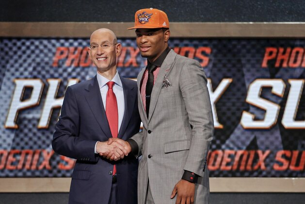 North Carolina State's T.J. Warren, right, poses for a photo with NBA Commissioner Adam Silver after being selected 14th overall by the Phoenix Suns during the 2014 NBA draft, Thursday, June 26, 2014, in New York. (AP Photo/Jason DeCrow)