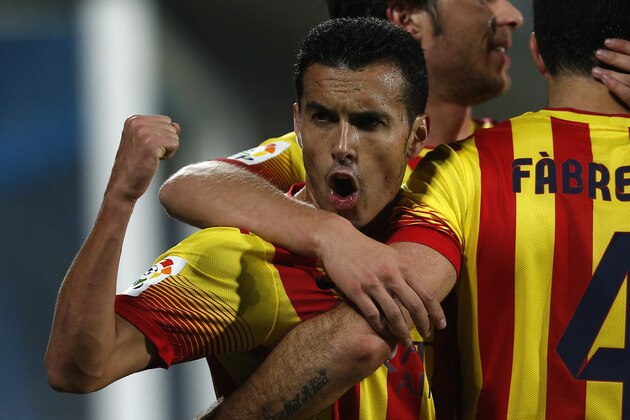 FC Barcelona's Pedro Rodriguez, left, celebrates Cesc Fabregas' goal with teammates during a Spanish La Liga soccer match between FC Barcelona and Getafe at the Coliseum Alfonso Perez stadium in Madrid, Spain, Sunday, Dec. 22, 2013. (AP Photo/Andres Kudacki)