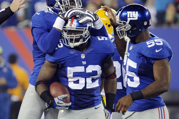 FILE - In this Nov. 17, 2013 file photo, New York Giants' Jon Beason (52) celebrates with teammates Jacquian Williams, left, and Keith Rivers (55) after Beason got an interception during the second half of an NFL football game against the Green Bay Packers, in East Rutherford, N.J. Beason has broken a bone in his right foot and is expected to miss most of training camp. The team announced Friday, June 13, 2014, that he also tore a ligament during Thursday's offseason training activity workout. (AP Photo/Bill Kostroun, File) FILE - In this Nov. 17, 2013 file photo, New York Giants' Jon Beason (52) celebrates with teammates Jacquian Williams, left, and Keith Rivers (55) after Beason got an interception during the second half of an NFL football game against the Green Bay Packers, in East Rutherford, N.J. Beason has broken a bone in his right foot and is expected to miss most of training camp. The team announced Friday, June 13, 2014, that he also tore a ligament during Thursday's offseason training activity workout. (AP Photo/Bill Kostroun, File)