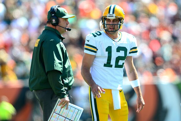 Sep 22, 2013; Cincinnati, OH, USA; Green Bay Packers head coach Mike McCarthy talks with quarterback Aaron Rodgers (12) during the second quarter against the Cincinnati Bengals  at Paul Brown Stadium. Mandatory Credit: Andrew Weber-USA TODAY Sports