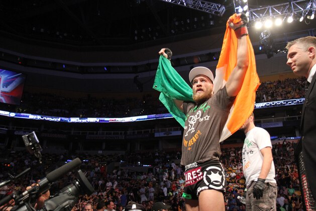 Conor McGregor, of Ireland, leaves the ring draped in an Irish flag after beathing Max Holloway in their UFC on Fox Sports 1 mixed martial arts bout in Boston, Saturday, August 17,2013. McGregor won via unanimous decision. (AP Photo/Gregory Payan) Conor McGregor, of Ireland, leaves the ring draped in an Irish flag after beathing Max Holloway in their UFC on Fox Sports 1 mixed martial arts bout in Boston, Saturday, August 17,2013. McGregor won via unanimous decision. (AP Photo/Gregory Payan)