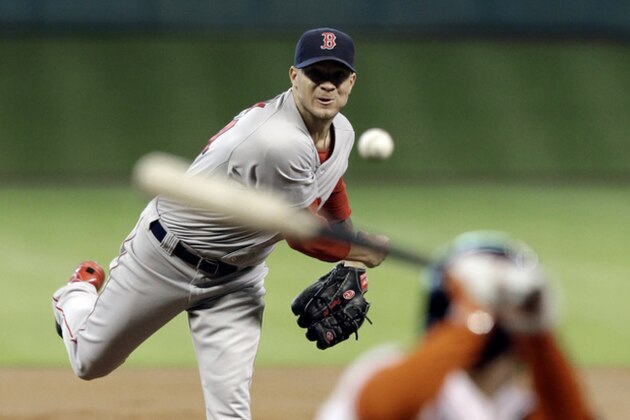 Boston Red Sox's Jake Peavy, left, delivers a pitch to Houston Astros' Jose Altuve in the first inning of a baseball game Saturday, July 12, 2014, in Houston. (AP Photo/Pat Sullivan)