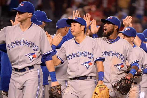 ANAHEIM, CA - JULY 08:  Jose Reyes #7 and Munenori Kawasaki #66 and Nolan Reimold #14 of the Toronto Blue Jays bow celebrate a 4-0 win over the Los Angeles Angels at Angel Stadium of Anaheim on July 8, 2014 in Anaheim, California.  (Photo by Harry How/Getty Images)