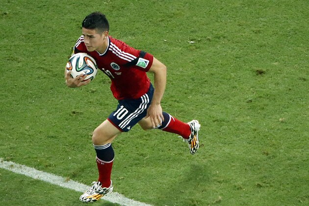 Colombia's James Rodriguez grabs the ball after scoring on a penalty during the World Cup quarterfinal soccer match between Brazil and Colombia at the Arena Castelao in Fortaleza, Brazil, Friday, July 4, 2014. (AP Photo/Fabrizio Bensch, pool)