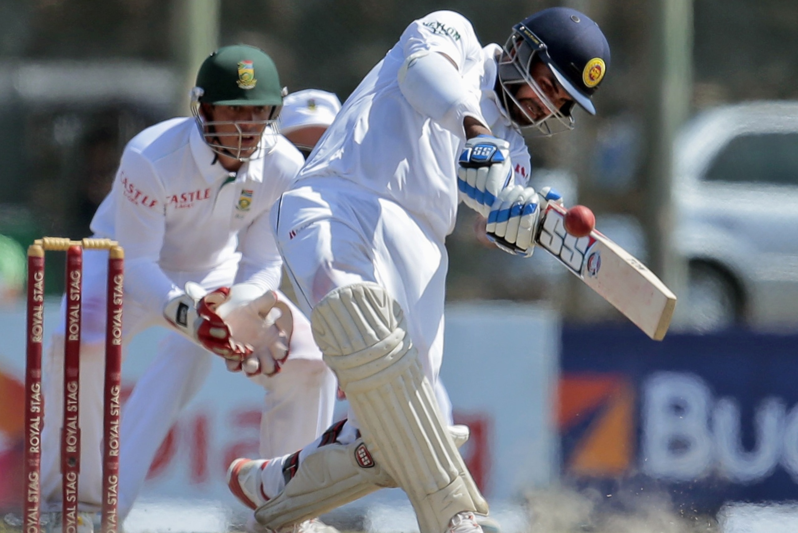 Sri Lanka's Lahiru Thirimanne plays a shot as South Africa's wicketkeeper Quinton de Kock watches in the third day of their first test cricket match in Galle, Sri Lanka, Friday, July 18, 2014. (AP Photo/Eranga Jayawardena)