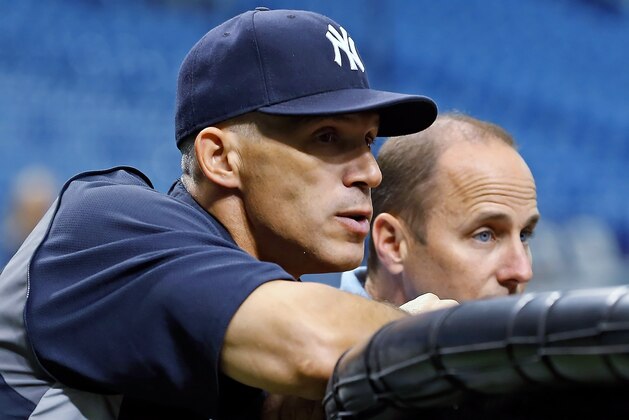 ST. PETERSBURG - SEPTEMBER 03: Manager Joe Girardi #28 and General Manager Brian Cashman of the New York Yankees watch their team during batting practice just before the start of the game against the Tampa Bay Rays at Tropicana Field on September 3, 2012 in St. Petersburg, Florida. (Photo by J. Meric/Getty Images) ST. PETERSBURG - SEPTEMBER 03: Manager Joe Girardi #28 and General Manager Brian Cashman of the New York Yankees watch their team during batting practice just before the start of the game against the Tampa Bay Rays at Tropicana Field on September 3, 2012 in St. Petersburg, Florida. (Photo by J. Meric/Getty Images)