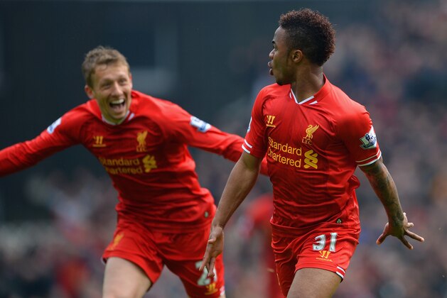 NORWICH, ENGLAND - APRIL 20:  Raheem Sterling of Liverpool celebrates scoring the opening goal with Lucas Leiva of Liverpool during the Barclays Premier League match between Norwich City and Liverpool at Carrow Road on April 20, 2014 in Norwich, England.  (Photo by Michael Regan/Getty Images)
