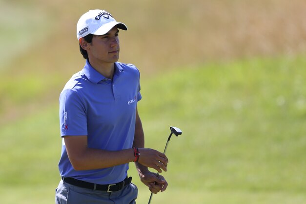 Matteo Manassero of Italy prepares to putt on the 13th green during the first day of the British Open Golf championship at the Royal Liverpool golf club, Hoylake, England, Thursday July 17, 2014. (AP Photo/Scott Heppell)