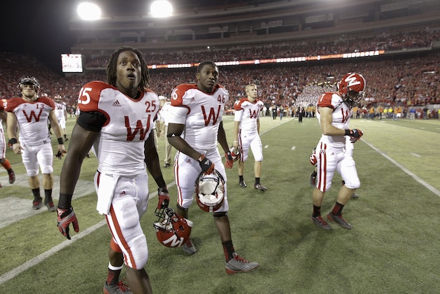 Wisconsin players including Melvin Gordon (25) and Austin Traylor (46) walk off the field following an NCAA college football game between Nebraska and Wisconsin, in Lincoln, Neb., Saturday, Sept. 29, 2012. Nebraska ran four straight scoring drives against a tiring Wisconsin defense in the second half to lead No. 22 Nebraska's comeback from a 17-point deficit to defeat the Badgers 30-27. (AP Photo/Nati Harnik)