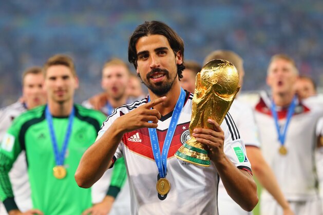RIO DE JANEIRO, BRAZIL - JULY 13:  Sami Khedira of Germany celebrates with the World Cup trophy after defeating Argentina 1-0 in extra time during the 2014 FIFA World Cup Brazil Final match between Germany and Argentina at Maracana on July 13, 2014 in Rio de Janeiro, Brazil.  (Photo by Martin Rose/Getty Images)