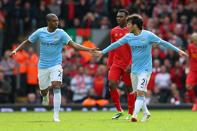 LIVERPOOL, ENGLAND - APRIL 13:  David Silva of Manchester City celebrates scoring his team's first goal with team-mate Fernandinho (L) during the Barclays Premier League match between Liverpool and Manchester City at Anfield on April 13, 2014 in Liverpool, England.  (Photo by Alex Livesey/Getty Images)