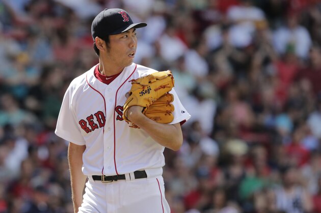 Boston Red Sox relief pitcher Koji Uehara (19) watches a home run by Minnesota Twins Chris Parmelee during a baseball game at Fenway Park in Boston, Wednesday, June 18, 2014. (AP Photo/Charles Krupa)