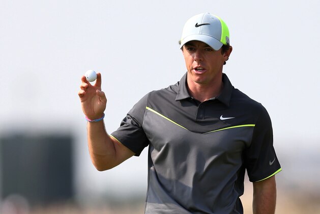 Rory McIlroy of Northern Ireland holds up his ball after playing a birdie on the 8th green during the second day of the British Open Golf championship at the Royal Liverpool golf club, Hoylake, England, Friday July 18, 2014. (AP Photo/Scott Heppell)