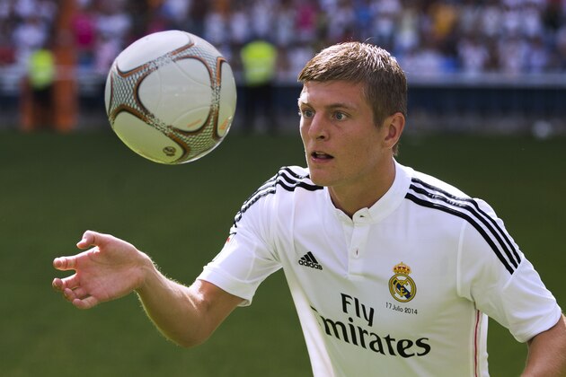 German international soccer player Toni Kroos, throws balls to supporters,  during his official presentation at the Santiago Bernabeu stadium in Madrid, Spain, Thursday, July 17, 2014, after signing for Real Madrid. (AP Photo/Andres Kudacki)