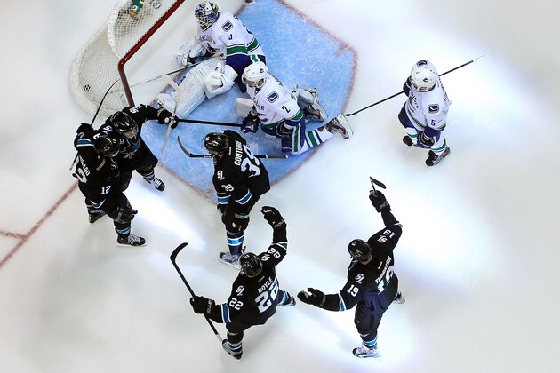 SAN JOSE, CA - MAY 07:  Joe Pavelski #8 of the San Jose Sharks celebrates with Patrick Marleau #12, Logan Couture #39, Dan Boyle #22 and Joe Thornton #19 after Pavelski scored a third period power play goal past goaltender Cory Schneider #35 and Dan Hamhuis #2 of the Vancouver Canucks in Game Four of the Western Conference Quarterfinals during the 2013 NHL Stanley Cup Playoffs at HP Pavilion on May 7, 2013 in San Jose, California. The Sharks defeated the Canucks 4-3 to sweep the series 4 games to 0.  (Photo by Christian Petersen/Getty Images)