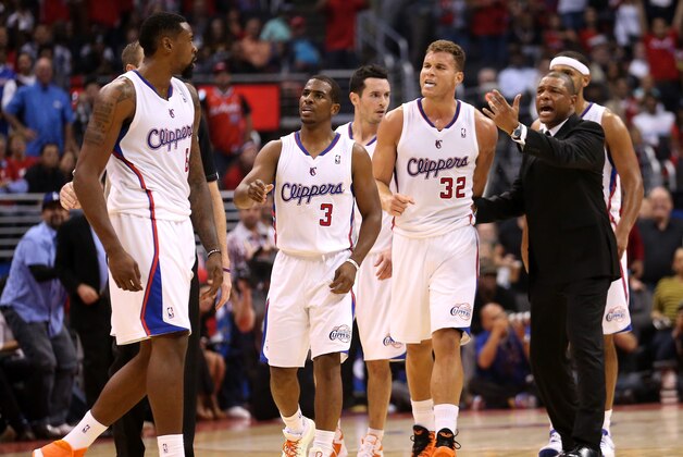 LOS ANGELES, CA - OCTOBER 31:  DeAndre Jordan #6 (L) of the Los Angeles Clippers is intercetped by Chris Paul #3, Blake Griffin #32, and head coach Doc Rivers after Jordan got in an altercation with Andrew Bogut #12 of the Golden State Warriors at Staples Center on October 31, 2013 in Los Angeles, California. The Clippers won 126-115.  NOTE TO USER: User expressly acknowledges and agrees that, by downloading and or using this photograph, User is consenting to the terms and conditions of the Getty Images License Agreement.  (Photo by Stephen Dunn/Getty Images)