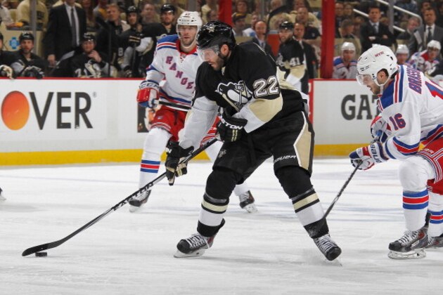 PITTSBURGH, PA - MAY 2:  Lee Stempniak #22 of the Pittsburgh Penguins moves the puck in front of Derick Brassard #16 of the New York Rangers in Game One of the Second Round of the 2014 Stanley Cup Playoffs at Consol Energy Center on May 2, 2014 in Pittsburgh, Pennsylvania.  (Photo by Gregory Shamus/NHLI via Getty Images)
