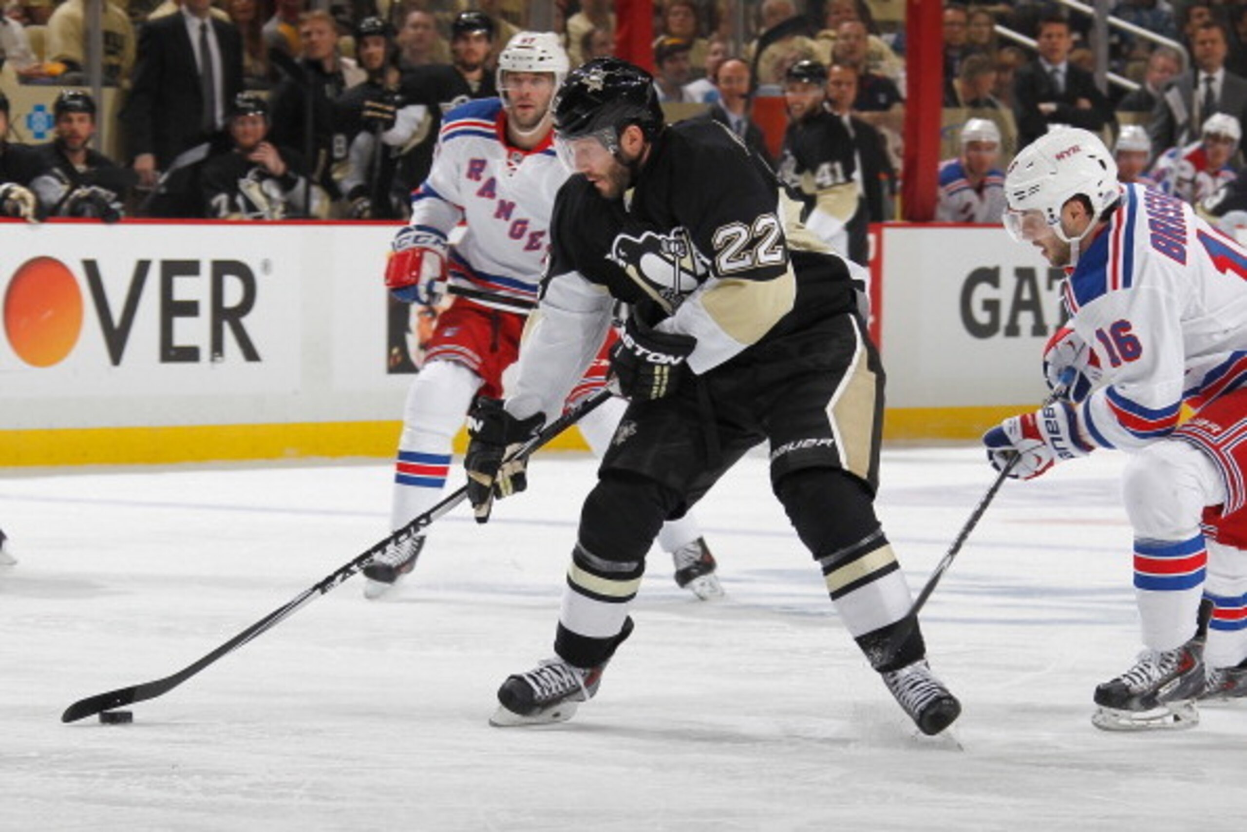 PITTSBURGH, PA - MAY 2:  Lee Stempniak #22 of the Pittsburgh Penguins moves the puck in front of Derick Brassard #16 of the New York Rangers in Game One of the Second Round of the 2014 Stanley Cup Playoffs at Consol Energy Center on May 2, 2014 in Pittsburgh, Pennsylvania.  (Photo by Gregory Shamus/NHLI via Getty Images)