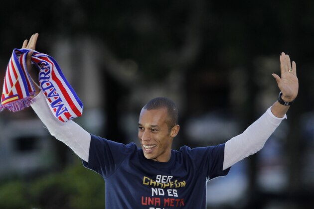 Atletico de Madrid's Joao Miranda from Brazil celebrates in Neptuno Square in Madrid, Spain, Saturday, May 18, 2013. Atletico de Madrid defeated Real Madrid in the Copa del Rey final soccer match on Friday. (AP Photo/Andres Kudacki)