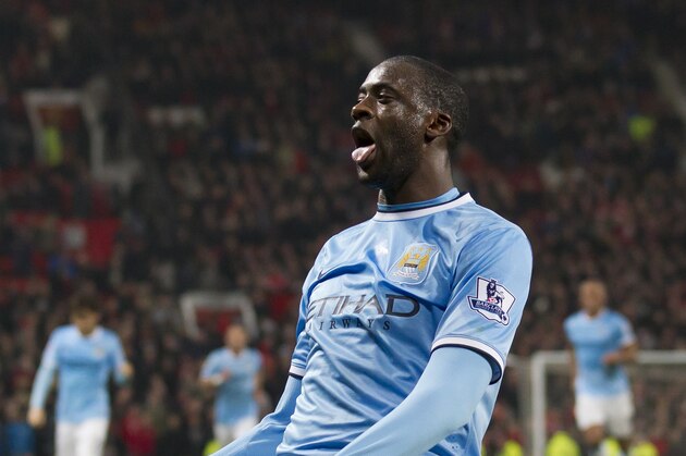 Manchester City's Yaya Toure celebrates after scoring against Manchester United during their English Premier League soccer match at Old Trafford Stadium, Manchester, England, Tuesday, March 25, 2014. (AP Photo/Jon Super)