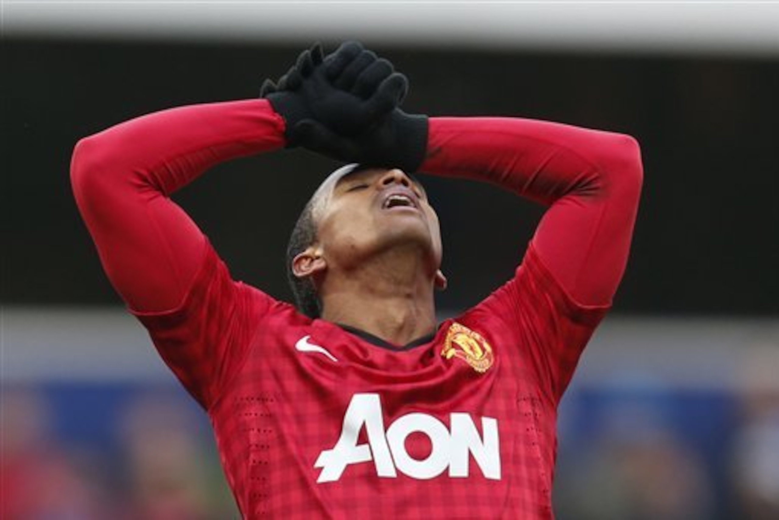 Manchester United's Nani reacts after missing a chance against Queens Park Rangers during their Premier League soccer match at Loftus Road ground in London, Saturday, Feb. 23, 2013. Manchester United won the match 2-0. (AP Photo/Lefteris Pitarakis)