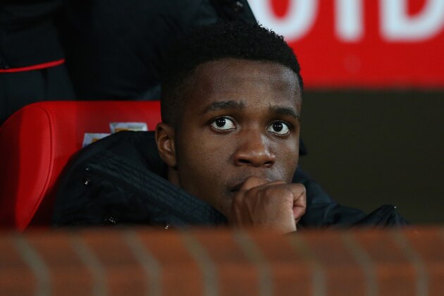 MANCHESTER, ENGLAND - JANUARY 05:  Wilfried Zaha of Manchester United looks on from the bench prior to the FA Cup with Budweiser Third round match between Manchester United and Swansea City at Old Trafford on January 5, 2014 in Manchester, England.  (Photo by Alex Livesey/Getty Images)