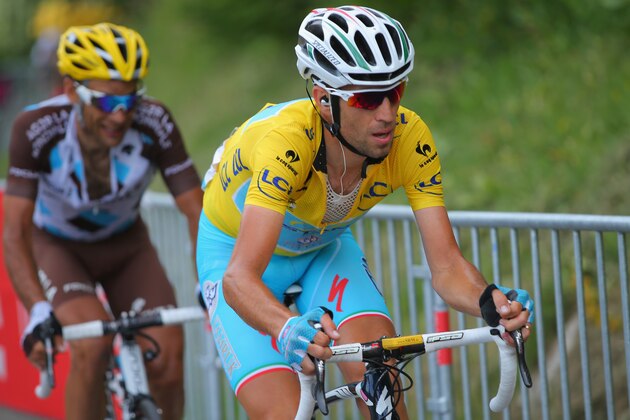 RISOUL, FRANCE - JULY 19:  Vincenzo Nibali of Italy and the Astana Pro Team defends the overall race leader's yellow jersey as he leads Jean-Christophe Peraud of France and AG2R La Mondiale on the climb to the finish during the fourteenth stage of the 2014 Tour de France, a 177km stage between Grenoble and Risoul, on July 19, 2014 in Risoul, France.  (Photo by Doug Pensinger/Getty Images)