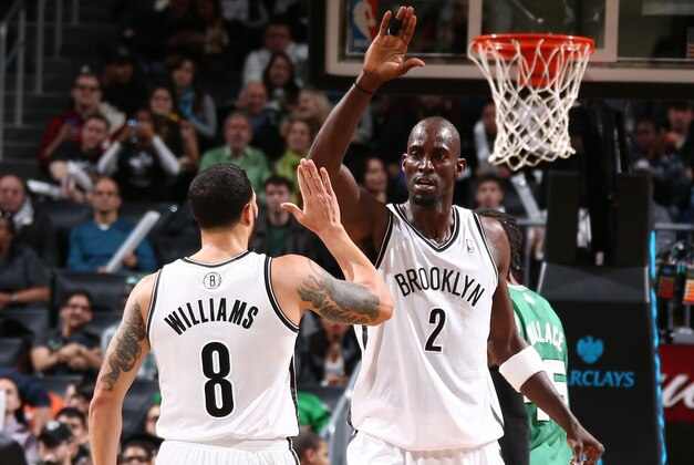 NEW YORK, NY - DECEMBER 10: Teammates Deron Williams #8  and Kevin Garnett #2 of the Brooklyn Nets high five during a game against the Boston Celtics at Barclays Center on December 10, 2013 in the Brooklyn borough of New York City.  NOTE TO USER: User expressly acknowledges and agrees that, by downloading and/or using this Photograph, user is consenting to the terms and conditions of the Getty Images License Agreement. Mandatory Copyright Notice: Copyright 2013 NBAE (Photo by Nathaniel S. Butler/NBAE via Getty Images)