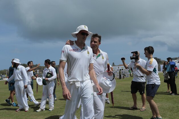 South African bowlers Morne Morkel, center left, and Dale Steyn cheer each others after defeating Sri Lanka by 153 runs during fifth day of the first test cricket match in Galle, Sri Lanka, Sunday, July 20, 2014. (AP Photo/Eranga Jayawardena)
