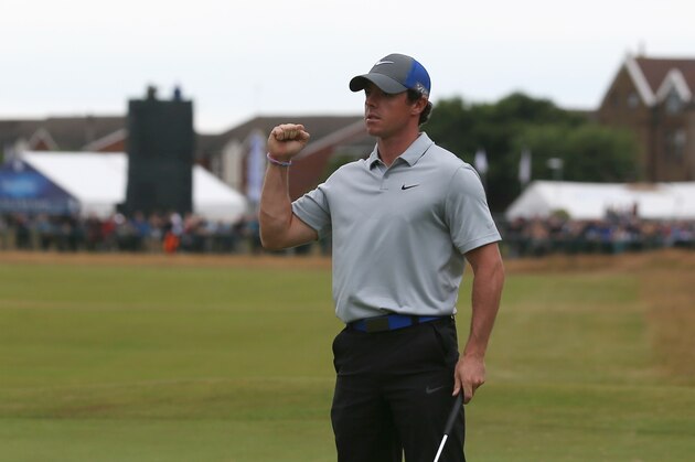Rory McIlroy of Northern Ireland celebrates after playing an eagle on the 18th green during the third day of the British Open Golf championship at the Royal Liverpool golf club, Hoylake, England, Saturday July 19, 2014. (AP Photo/Jon Super)