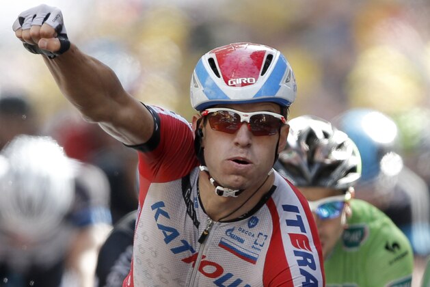 Norway's Alexander Kristoff crosses the finish line to win the fifteenth stage of the Tour de France cycling race over 222 kilometers (137.9 miles) with start in Tallard and finish in Nimes, France, Sunday, July 20, 2014. (AP Photo/Peter Dejong)