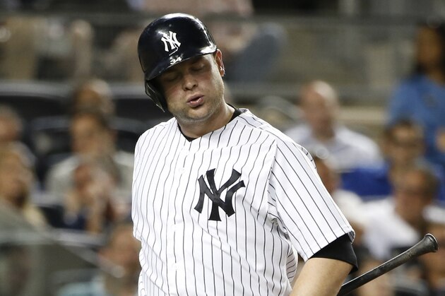New York Yankees catcher Brian McCann (34) reacts after striking out in a baseball game against the Tampa Bay Rays at Yankee Stadium in New York, Monday, June 30, 2014.  (AP Photo/Kathy Willens)