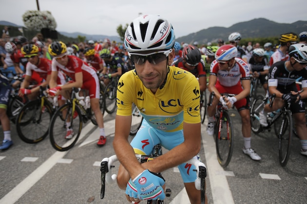 Italy's Vincenzo Nibali, wearing the overall leader's yellow jersey, poses for photographers prior to the fifteenth stage of the Tour de France cycling race over 222 kilometers (137.9 miles) with start in Tallard and finish in Nimes, France, Sunday, July 20, 2014. (AP Photo/Christophe Ena)
