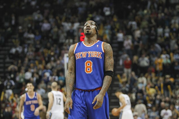 New York Knicks guard J.R. Smith (8) shows his disappointment in the closing seconds against the Memphis Grizzlies in the second half of an NBA basketball game Tuesday, Feb. 18, 2014, in Memphis, Tenn. The Grizzlies won 98-93. (AP Photo/Lance Murphey)