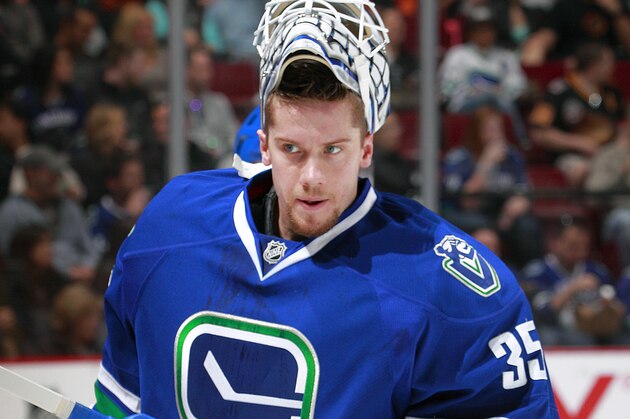 VANCOUVER, BC - APRIL 13:  Jacob Markstrom #35 of the Vancouver Canucks looks on from the bench during their NHL game against the Calgary Flames at Rogers Arena April 13, 2014 in Vancouver, British Columbia, Canada.  Vancouver won 5-1. (Photo by Jeff Vinnick/NHLI via Getty Images)